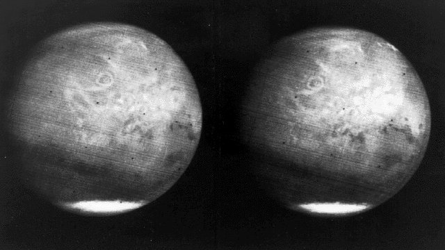 Approach view of Mars from Mariner 7 The southern ice cap and Nix Olympica (circle in northern hemisphere) are visible.
