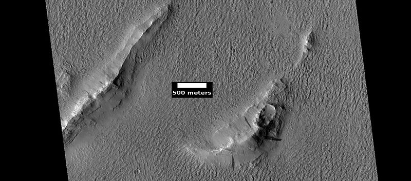 Layers and dark slope streaks in Lycus Sulci, as seen by HiRISE under HiWish program