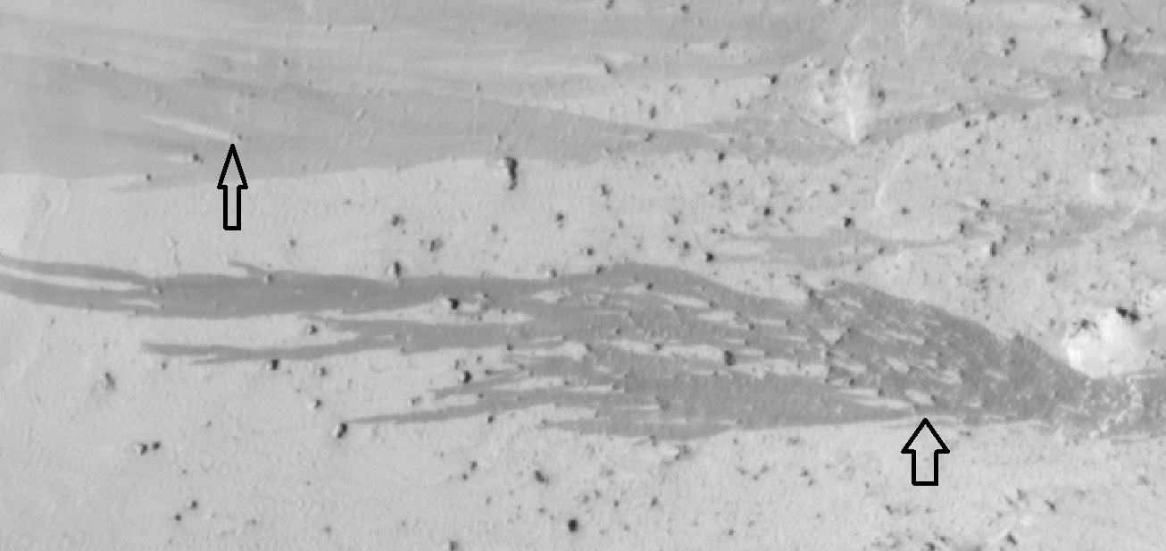 Dark slope streaks, as seen by HiRISE under the HiWish program Arrows show how boulders affected the shape of the streaks.