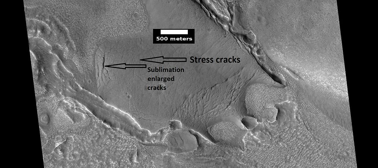 View of stress cracks and larger cracks that have been enlarged by sublimation (ice changing directly into gas) This may be the start of ribbed terrain.